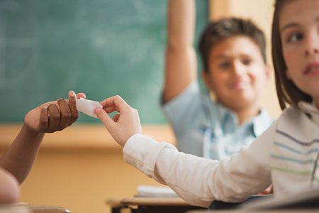 Girl passing a note in classの写真素材