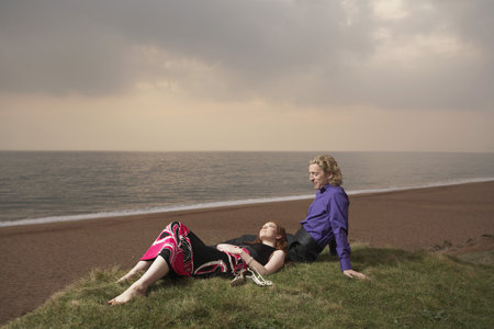 Couple sitting next to a beachの写真素材