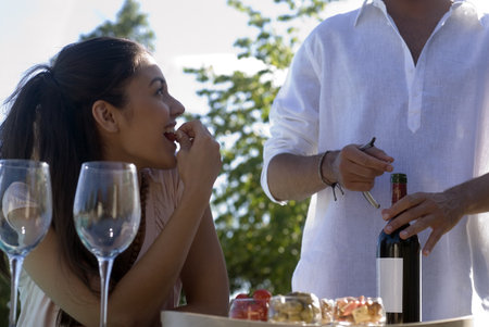 Young couple enjoying wine and appetizersの写真素材
