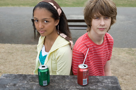 Teenage boy and girl with drinksの写真素材