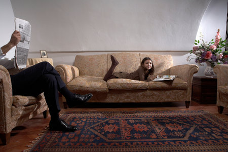 Man reading newspaper with daughterの写真素材