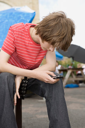 Teenage boy with cellphoneの写真素材