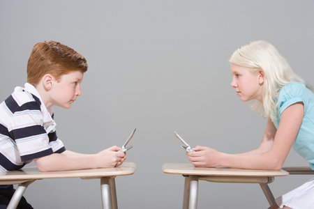 Girl and boy with mobile phonesの写真素材