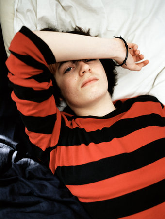 Teenage boy lying on bed