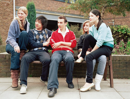 Teenagers on a benchの写真素材