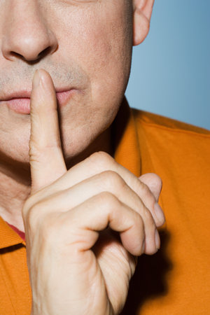 Man with finger on lipsの写真素材