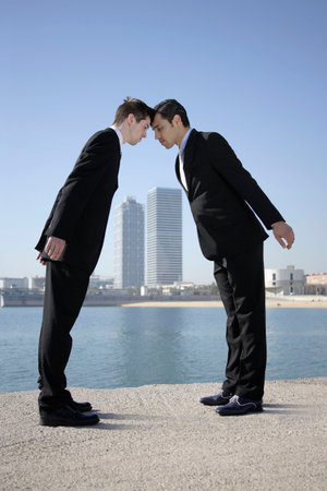 Business men head to head by seafrontの写真素材