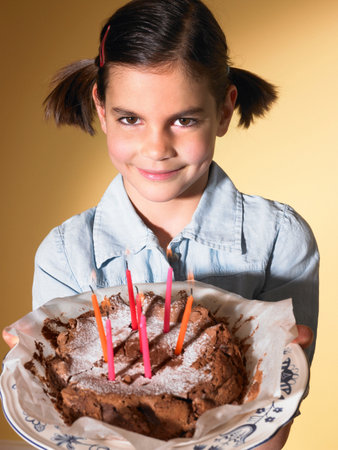 Girl holding a birthday cakeの写真素材