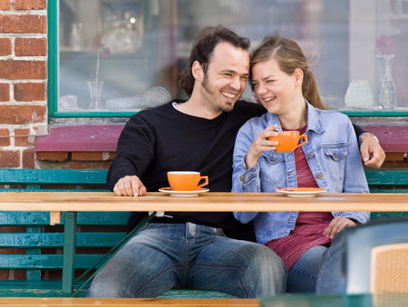 Man and woman sitting at a cafeの写真素材