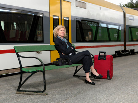 Mature woman on train stationの写真素材