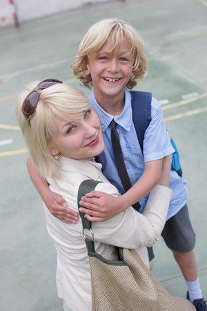 School boy hugging motherの写真素材