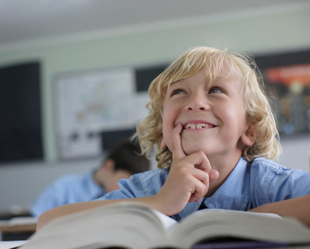 School boy thinking in classの写真素材