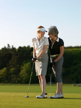 Two women on golf greenの写真素材