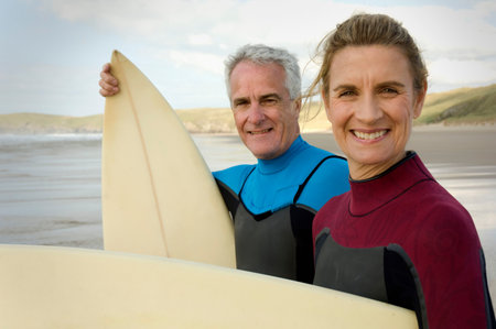 Couple with surfboards on a beachの写真素材