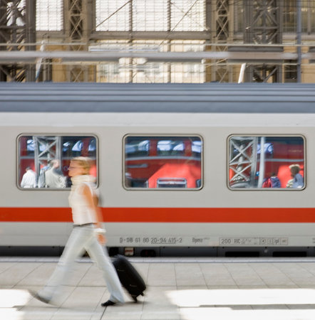 Blur of woman walking past trainの写真素材