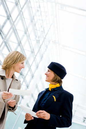 Woman talking to stewardessの写真素材