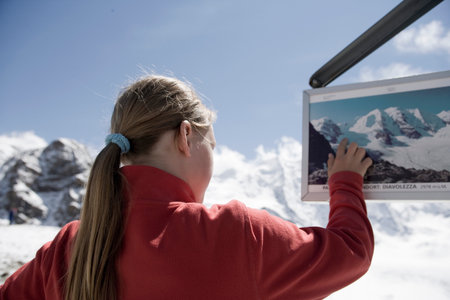 girl looking around in mountainous areaの写真素材