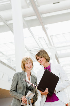 Two women looking at filesの写真素材