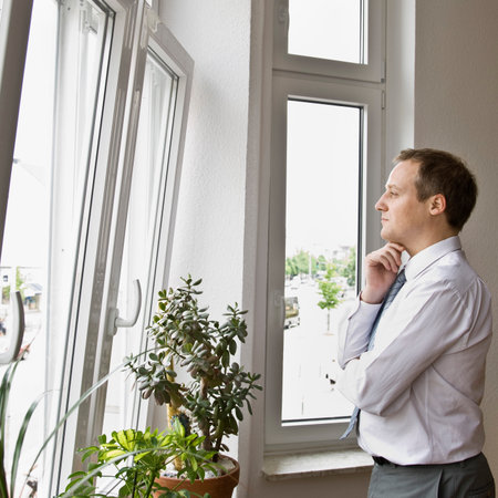 Man looking out windowの写真素材
