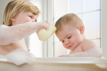 Two baby sisters in the bath.の写真素材