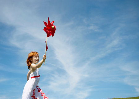 Young girl running with windmillの写真素材