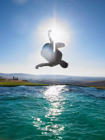 Man jumping in swimming poolの写真素材