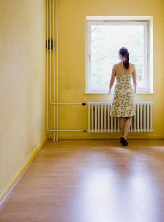 Woman looking out a windowの写真素材