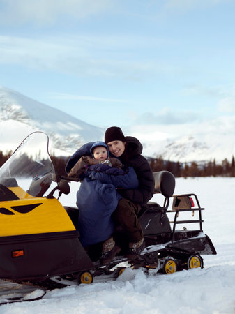 Mother and baby on Snowmobileの写真素材