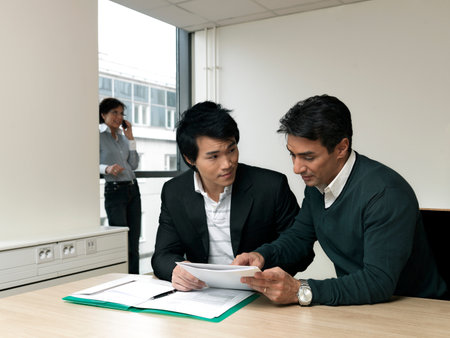Business man helping traineeの写真素材