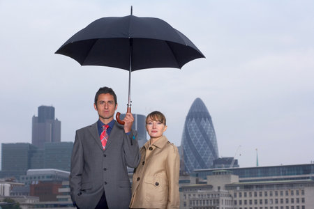Man & Woman with Umbrella City Scapeの写真素材