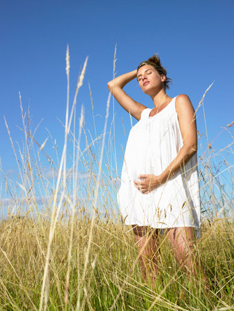 Pregnant woman in a fieldの写真素材