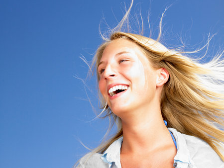 Woman smiling,  blue sky aboveの写真素材