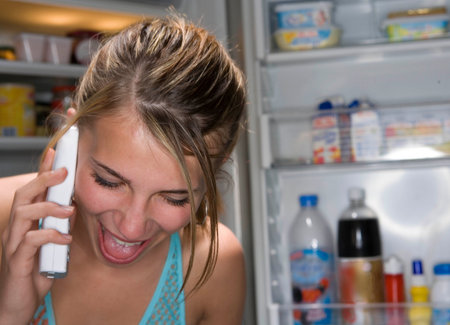 Teen laughing girl on telephoneの写真素材