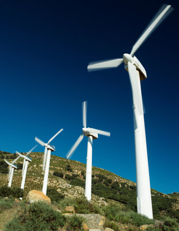Wind turbines against stormy skyの写真素材
