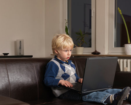 Toddler working on laptopの写真素材