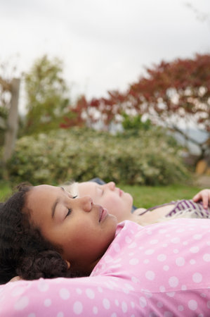 Girls resting on tentの写真素材