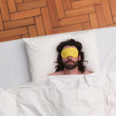 Man sleeping, wearing eye-maskの写真素材