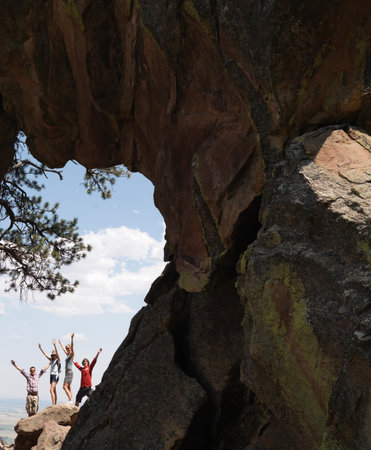 Cheering friends under rock formationの写真素材