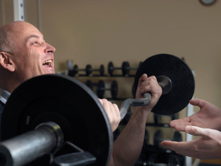 man exercising with weights at gymの写真素材