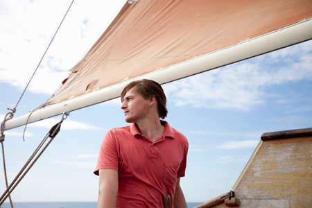 Man standing under a sailの写真素材