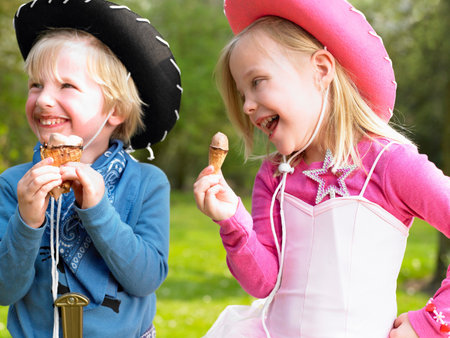 Kids with costume, eating ice-creamの写真素材