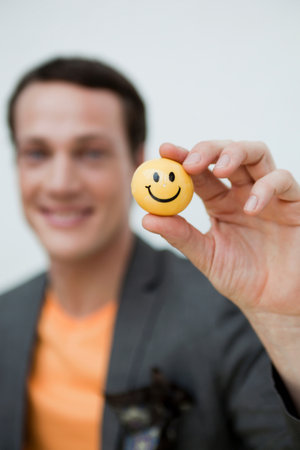 man showing a toy ball to viewer