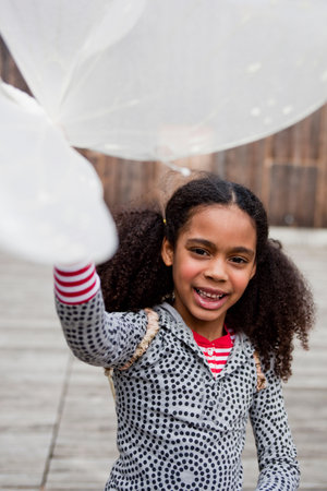 young girl playing with toy wingsの写真素材