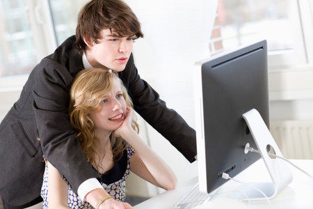 man is teaching something to a womanの写真素材