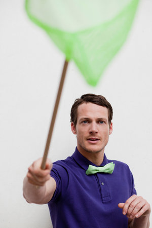 man playing with butterfly netの写真素材