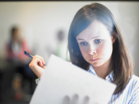 woman writing against windowの写真素材