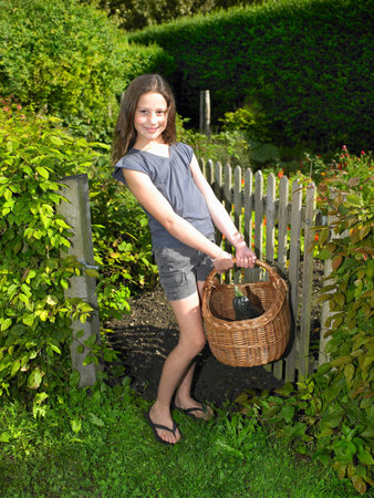 Girl in her vegetable gardenの写真素材
