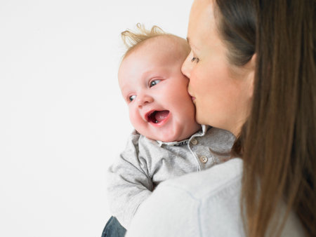 mother kissing babyの写真素材