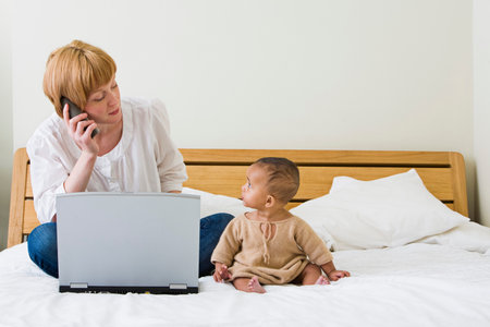 Mother & baby on bedの写真素材