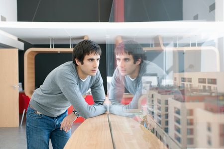 young man looking at construction model